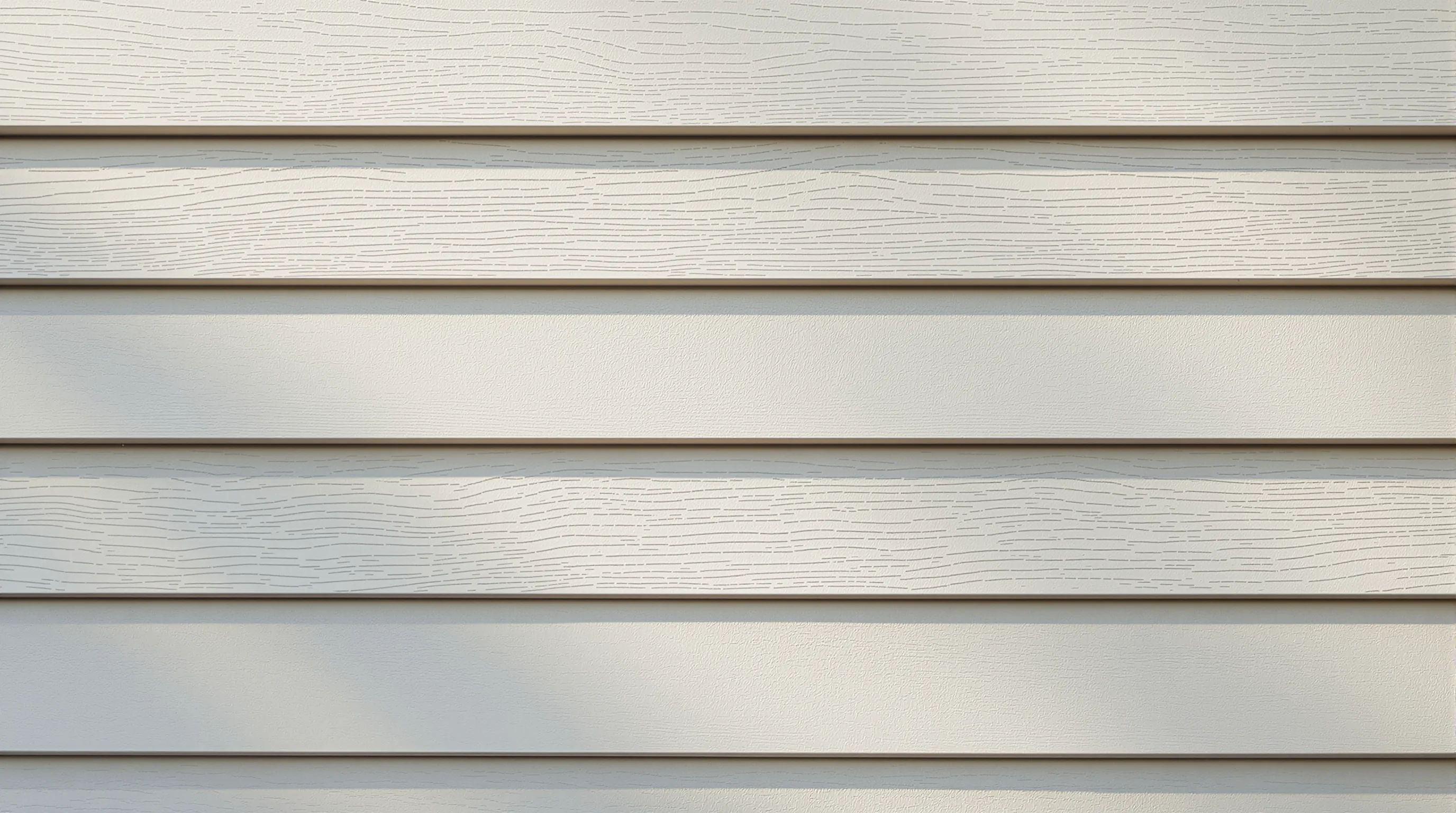 Close-up of fiber cement lap siding texture and finish detail on Virginia home exterior